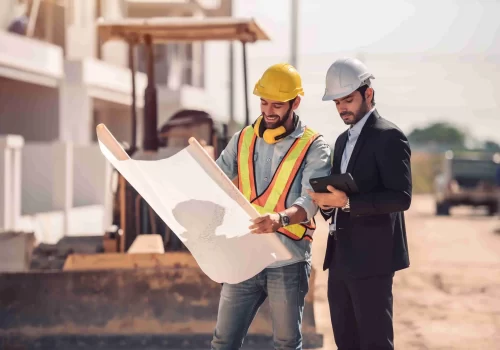 civil-engineer-construction-worker-manager-holding-digital-tablet-blueprints-talking-planing-about-construction-site-cooperation-teamwork-concept_11zon