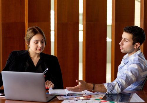 front-view-young-attractive-businesswoman-black-shirt-black-jacket-along-with-young-man-discussing-work-issues-inside-her-office-work-job-building_140725-16134